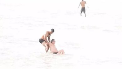 World rugby star who can 'barely swim' saves man's life in dramatic beach rescue